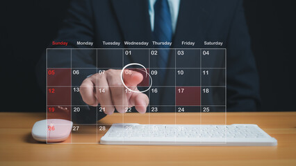 Businessman marking dates on virtual calendar, managing his business schedule, setting reminders...