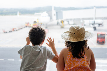 Girl and boy on vacation at international airport