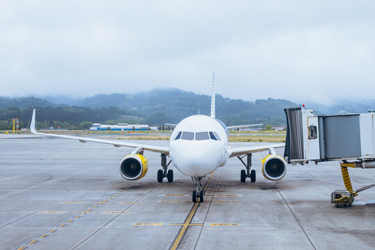 Aircraft at runway against sky - Powered by Adobe