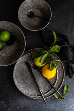 Elegant table setting with citrus and dark tones