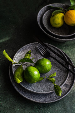 Fresh limes on dark plate with elegant presentation