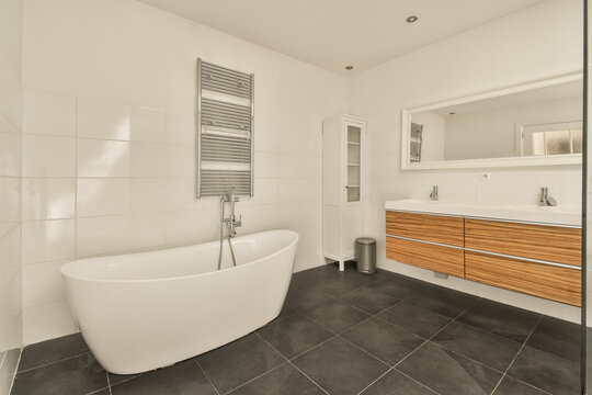 Bathroom with white bathtub and sinks