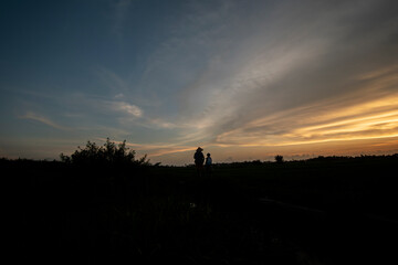 Obraz na płótnie Canvas Silhouette photo at sunset with a beautiful sky background