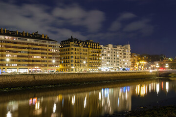 Fototapeta na wymiar Night view of the old town by the coast in San Sebastián, Spain
