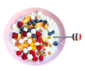 Oatmeal porridge with fruit, berries and mini marshmallow with spoon on wooden background table top...