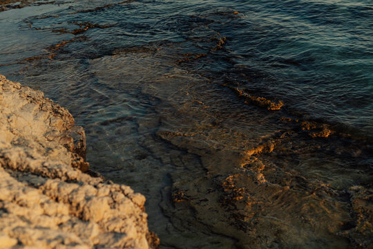 Sunset glow and waves on coastal waters