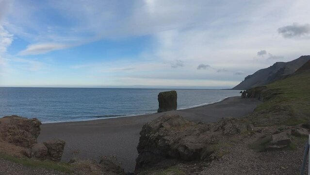 SLOW MOTION SHOT - Stapinn sea stack at Stapav&iacute;k is a unique part of the stunning coast south of &Aacute;lftafj&shy;&ouml;r&eth;ur in Iceland.