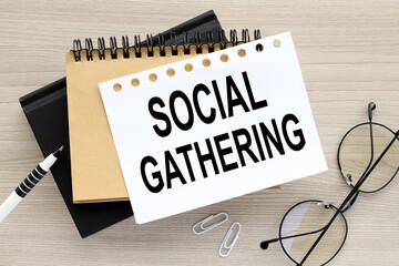 the words SOCIAL GATHERING on a white page on two notepads