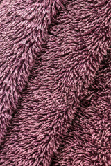 Fluffy luxurious purple towel texture macro background