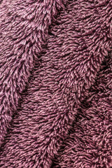 Fluffy luxurious purple towel texture macro background