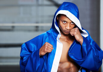 Black man, boxer and champion in robe at gym getting ready for fight, challenge or sports...