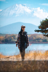 Happy tourist traveler woman or man enjoying on lake kawaguchiko with mount fuji in japan, spring...