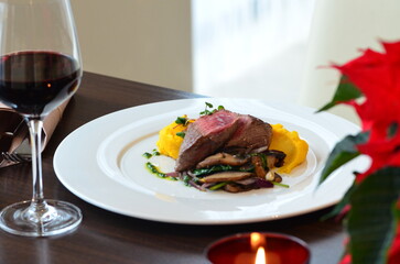beef fillet mignon with puree on white plate,