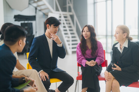 Group of multiethnic business people working and talking discussion in modern office, Businessman and businesswoman sitting around a conference table of business meeting seminar room