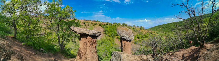 Landscape with stone mushrooms in the Crimea on a clear sunny day. Huge stone blocks, similar to...