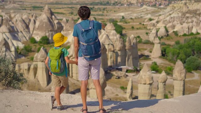Embark on a journey as a young father and his son explore the enchanting Goreme National Park in Cappadocia, Turkey. Marvel at the surreal rock formations that characterize this unique landscape.