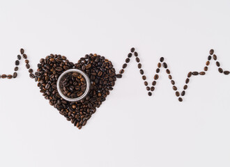 Creative layout with heart shape made of roasted coffee beans and coffee cup showing relationship...