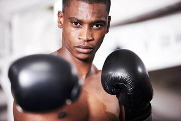 Boxing, gloves and punch, portrait of black man with fitness and power for training challenge. Strong body, muscle and hands of boxer in gym, athlete with fist up and confidence in competition fight.