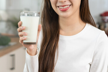 Health care, pretty asian young woman, girl drinking a glass of white fresh, dairy milk for...