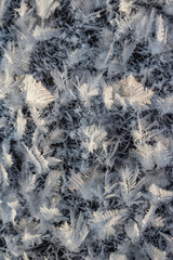 Large crystalline frost grown on ice on a frosty day close-up, northern nature