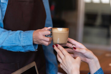woman baristas follow recipes to create artisan and specialty beverages.Small business owners practice the sense of taste