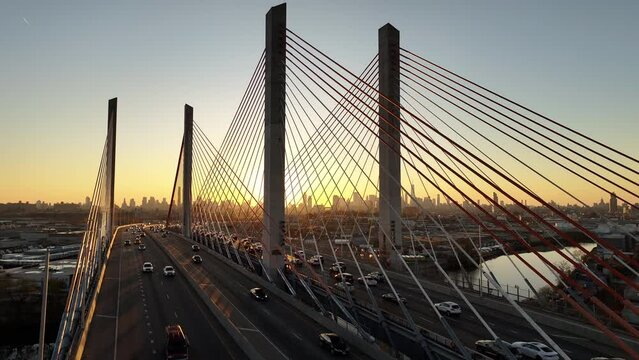 Aerial shot of rush hour traffic crossing the Kosciuszko Bridge at sunset.