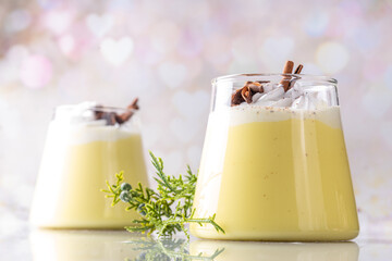 Creamy Homemade Eggnog Pudding, Musse Dessert in glasses, with whipped cream and spices, sweet...