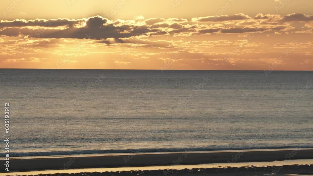 Wall mural Beautiful evening sunset with big Sun and clouds in the Atlantic Ocean at Portugal coast.