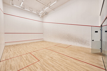 squash court with white walls and polished floor, motivation and determination concept