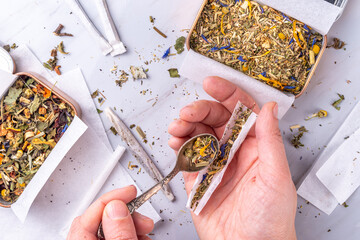 Alternative healthy herbal smoking blend. Handmade craft cigarette, preparation process, with...
