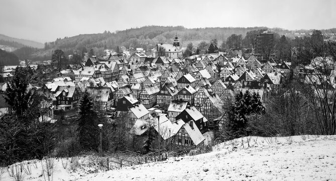 Freudenberg panorama in Sauerland Germany with historic black and white truss half timbered houses in the old town called “Alter Flecken“. Idyllic scenery on a snowy winter day at christmas time. 