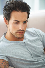 Fototapeta premium Man, thinking and sofa for problem in home or lonely grief mourning, broken heart or stress. Male person, unhappy thoughts on couch for depressed risk or sad loss from anxiety, mental health or fail