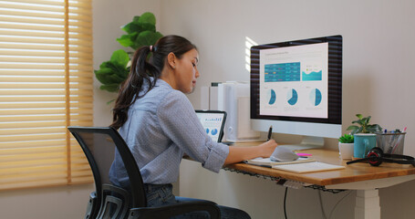 Smart Gen Z tech talent workforce typing SEO sale report on desktop PC happy work easy relax at...