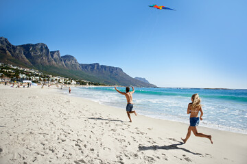 Couple, running and summer with kite, beach and summer sunshine for vacation, freedom or play in air. Man, woman and speed to launch wind toys, bonding or holiday by sea on adventure in Naples, Italy