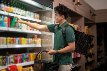 An Asian man delivery choosing goods from online order in supermarket , online delivery service...