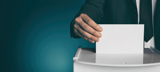 Man putting his vote into ballot box on gradient color background, closeup. Banner design with...