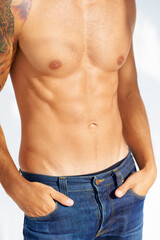 Relax, body and jeans with a man in studio isolated on a white background closeup for masculine style. Fashion, muscle or macho and a cool, shirtless person in denim with his hands in his pockets