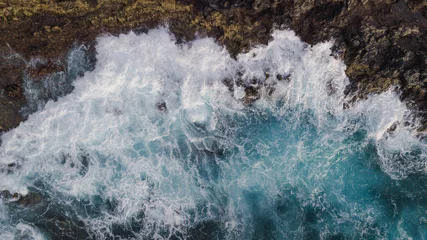 Photo sur Plexiglas les îles Canaries Drone view of Atlantic ocean with strong swell beating against the walls of a rocky cliff, blue rough sea with big waves with foam crashing against the rocks, south of Tenerife, Canary island