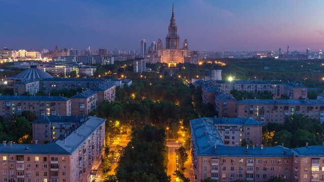 Moscow State University night to day transition timelapse before sunrise aerial view from rooftop. Popular landmark in Moscow the capital of Russia. Early morning mist