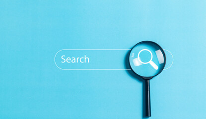 SEO concept, Magnifying glass focus to search engine bar on blue background, Data search technology...