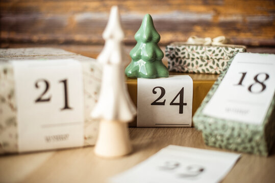 Gifts for an advent calendar next to Christmas decorations