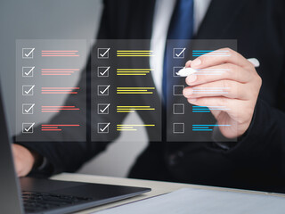 Businessman using laptop to survey online checklist Complete the digital form checklist Business performance checklist concept. - obrazy, fototapety, plakaty