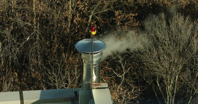 4k movie of the smoke from heating instalation from a house coming out of a chimney in a winter day.