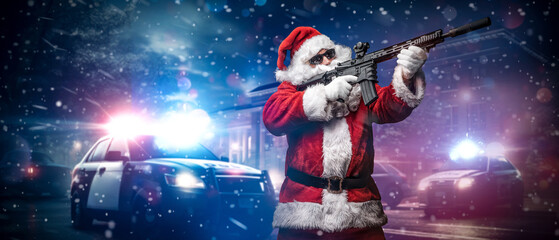 A man dressed as Santa Claus, holding a machine gun, poses in front of police cars with numerous...