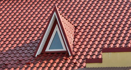 The roof of the house is covered with metal tiles