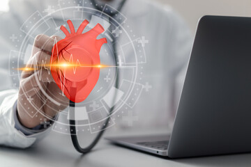 Cardiologist doctor touching heartbeat icon on virtual screen for checking the function of the...