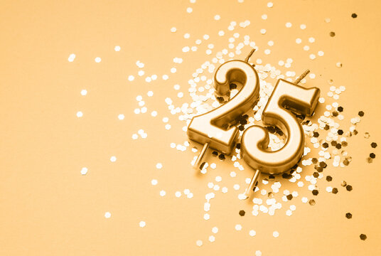 25 years birthday celebration festive background made with golden candle in the form of number Twenty five lying on sparkles. Universal holiday banner with copy space. - Powered by Adobe