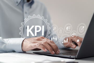 Key Performance Indicator concept. businessman using laptop with KPI icons on virtual screen to...