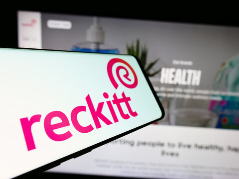 Stuttgart, Germany - 11-21-2023: Mobile phone with logo of consumer goods company Reckitt Benckiser Group plc in front of website. Focus on center-right of phone display.