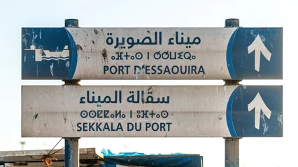 Papier Peint photo Atlantic Ocean Road Road sign showing the direction for Essaouira city and Sqala du Port, the main port of Essaouira.